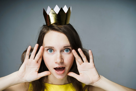 amazed woman with a crown on her headの写真素材