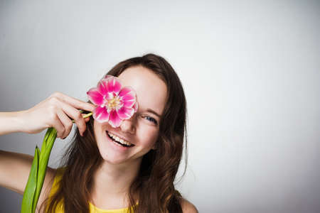 happy woman holding a tulip in hands, March 8の写真素材