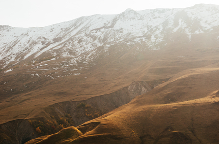 high beautiful snow-capped mountains on a sunny dayの写真素材
