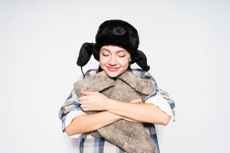 Russian girl holding felt boots on gray backgroundの写真素材