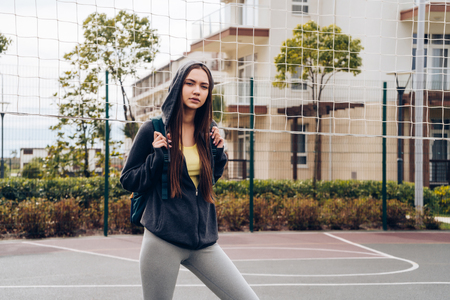 energetic young girl in sportswear actively engaged in sports, street training and inspirationの写真素材
