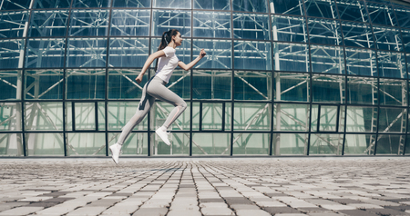 active young girl jogging on the street, motivation and inspiration, street workoutの写真素材