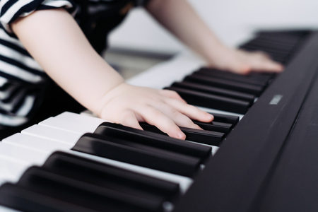 a young child learns to play the piano, has fun and studies the world