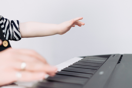 little baby boy plays the piano, loves musicの写真素材