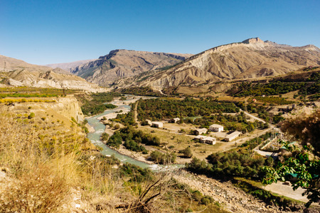 Charming nature, mountain slopes and hills in the sun, many green trees