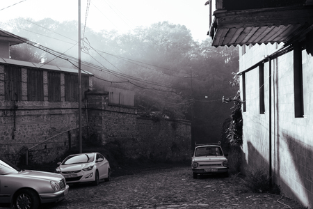 old brick houses and a narrow street in the summer sunshineの写真素材
