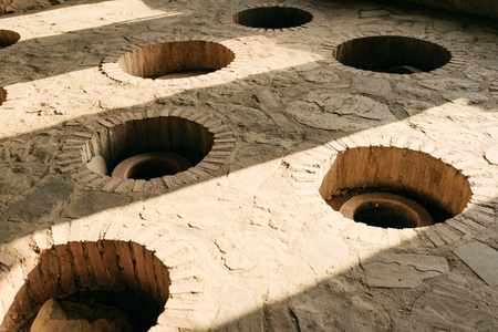 alcohol industry, winery, in the stone floor special holes for wine storageの写真素材