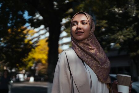proud muslim woman with a beautiful face walks down the streetの写真素材