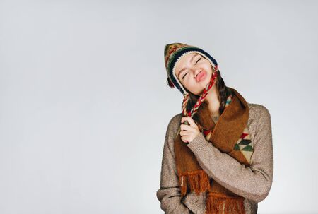 girl makes faces in studio light grayの写真素材