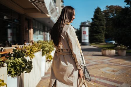 attractive European turned over her shoulder and walks past a cafeの写真素材