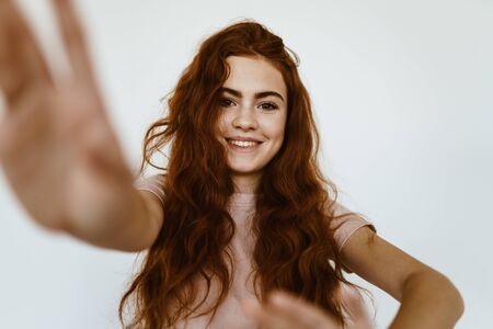 cute schoolgirl smiling with a negative gesture hands looking at the cameraの写真素材