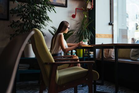 student doing homework on tablet pc sitting at the tableの写真素材