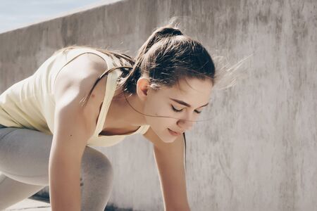 concentrating, the runner girl got ready for the start