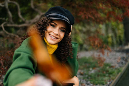 Girl in autumn park in stylish clothes smiling and posing. High quality photoの写真素材