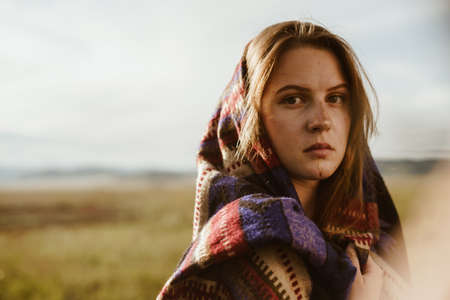 close-up. A girl in the steppe wrapped in an ethno cape stares sternly into the camera, the natural beauty without makeup. High quality photoの写真素材