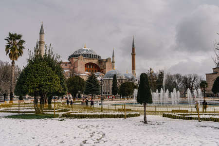 ISTANBUL, TURKEY - FEBRUARY 15, 2020: Istanbul winter a day. St. Sophia Cathedral in snow.People walking in Sultanahmet District under snow.のeditorial素材
