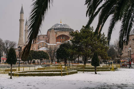 ISTANBUL, TURKEY - FEBRUARY 15, 2020: Istanbul winter a day. St. Sophia Cathedral in snow.People walking in Sultanahmet District under snow.のeditorial素材