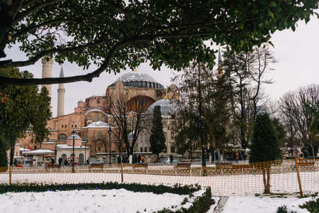 ISTANBUL, TURKEY - FEBRUARY 15, 2020: Istanbul winter a day. St. Sophia Cathedral in snow.People walking in Sultanahmet District under snow.のeditorial素材