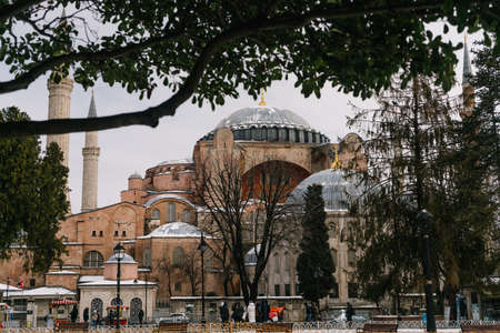 ISTANBUL, TURKEY - FEBRUARY 15, 2020: Istanbul winter a day. St. Sophia Cathedral in snow.People walking in Sultanahmet District under snow.のeditorial素材