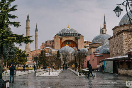 ISTANBUL, TURKEY - FEBRUARY 15, 2020: Istanbul winter a day. St. Sophia Cathedral in snow.People walking in Sultanahmet District under snow.のeditorial素材