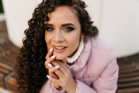 close-up. girls face with lovely green eyes with a smile of the palm of her hand in the palm of her...