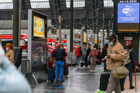 4.10.2021 Milan, Italy - Milano Centrale railway station. People crowd around waiting for the train....