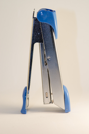 Silver and blue stapler with white backgroundの写真素材
