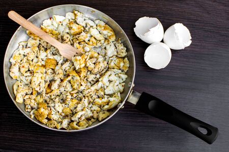 Two whole eggs and five egg whites scrambled in coconut oil in a pan with oregano and chilly flakes to make a protein rich (30 grams) dishの写真素材
