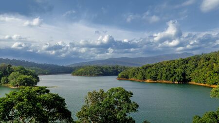 Landscape view of a lake surrounded by forested hillsの写真素材