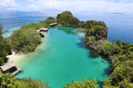 Aerial view of Rufas island with its lagoon in the middle located in Raja Ampat, West Papua, Last...