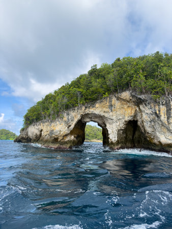 Rock Arch and Limestone Cliff in Wayag via which you go through during tours with a boat, in slang it is called stone door, Raja Ampat, West Papua, Indonesiaの写真素材