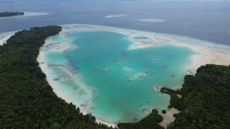 Aerial view of uninhabited small islands in West Waigeo, surrounded by vibrant coral reefs and crystal-clear turquoise waters.の写真素材