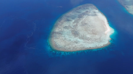 Aerial view of uninhabited small islands in West Waigeo, surrounded by vibrant coral reefs and crystal-clear turquoise waters.の写真素材