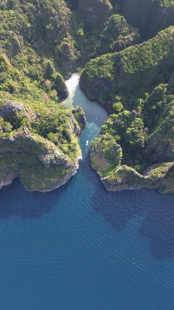 Stunning aerial footage of Wang Long Bay, a hidden limestone cove with turquoise waters in the Phi Phi Islands of southern Thailand.の写真素材
