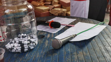 Close-up of a microphone and items on a table, ready for an eventの写真素材