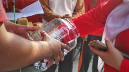 Raffle Drawing Hands Reach into Clear Jar at Community Eventの写真素材