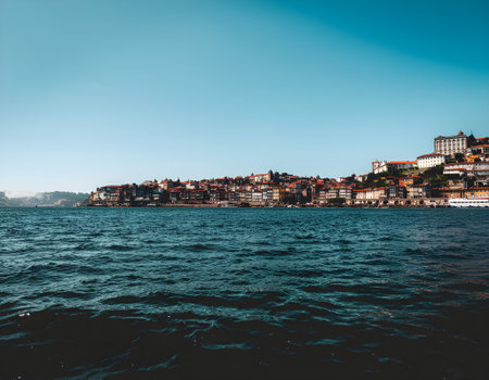 Scenic view of the historic cityscape of Porto from the deep blue watersの素材