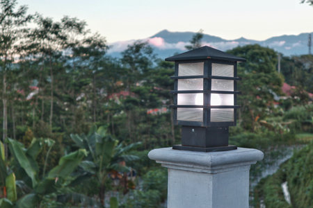 A contemporary outdoor light fixture mounted on a clean white wall, designed for illuminating a gate or pathway, emphasizing modern home exterior design.の写真素材