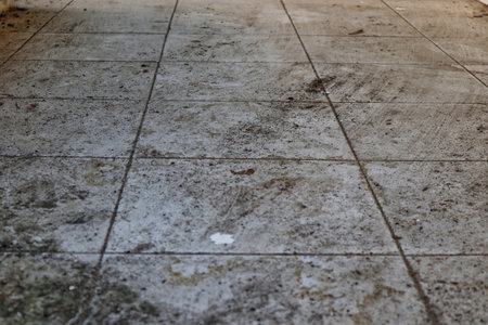 A detailed close-up of a floor or surface, creating a rough and industrial texture suitable for grunge or abstract backgrounds.の写真素材