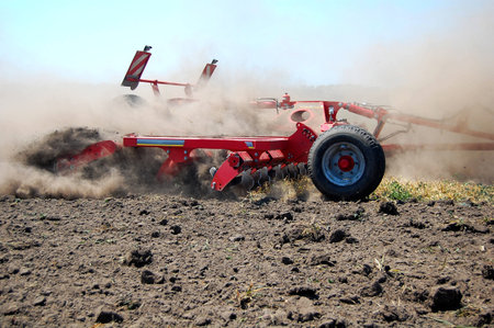 Harrow is tilling soil before seeding on the high speedの写真素材