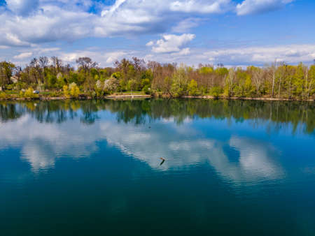 Blue lake in the forest reflectionの写真素材