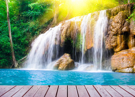 Scenic of waterfall and wood bridge surrounded by lush plant の写真素材