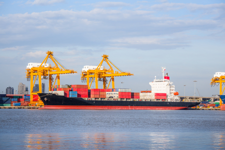 Cargo ship working with crane at port.の写真素材