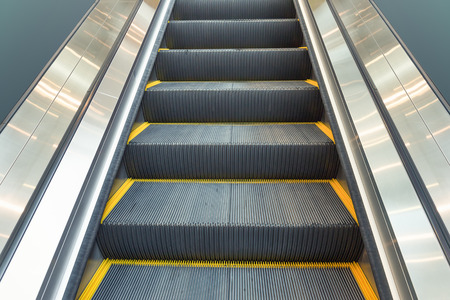 Escalator and step inside building.