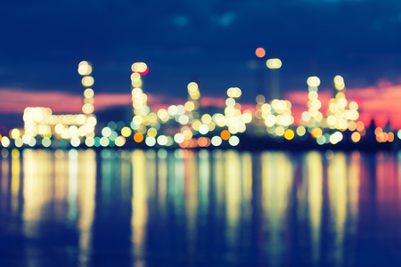 Bokeh of oil refinery factory at twilight, vintage color tone.の写真素材