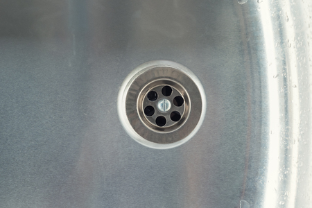 Water drain hole in stainless steel sink.の写真素材