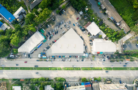 Aerial view of fresh market building beside road and customer vehicle on car park in Amphur Sansai...