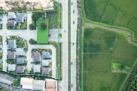 Housing estate and road in aerial view. Village or community with residential building in land lot....