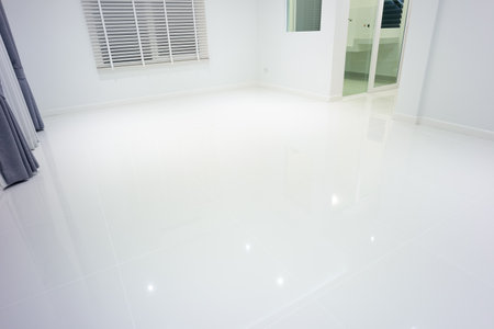 White empty space or room at night with ceramic tile floor in perspective view, venetian blind. Modern luxury interior home design of living room look clean, bright, shiny surface for background.の写真素材