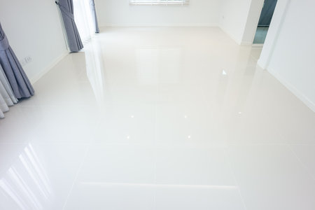 White tile floor with grid line of square texture pattern in perspective. Clean shiny of ceramic surface. Modern interior home design for bathroom, kitchen and laundry room. Empty space for backgroundの写真素材